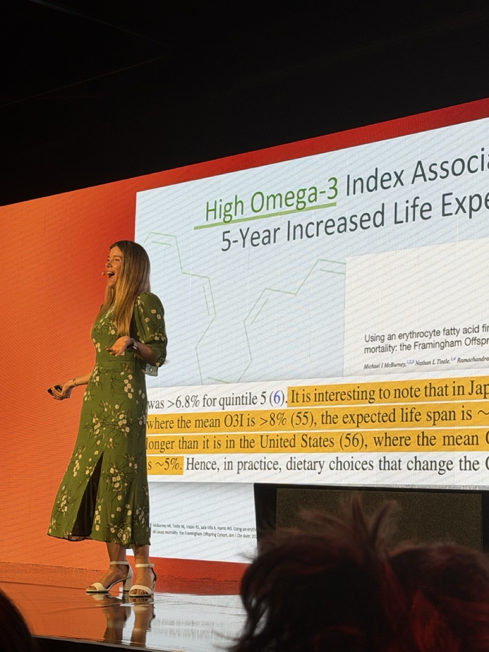 Dr Rhonda Patrick on stage at Healf HX26 with the Framingham omega-3 slide